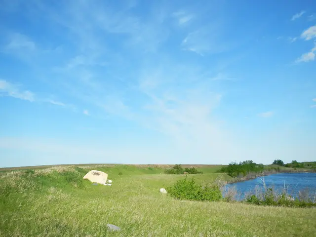 Prairie pond and grassy hills