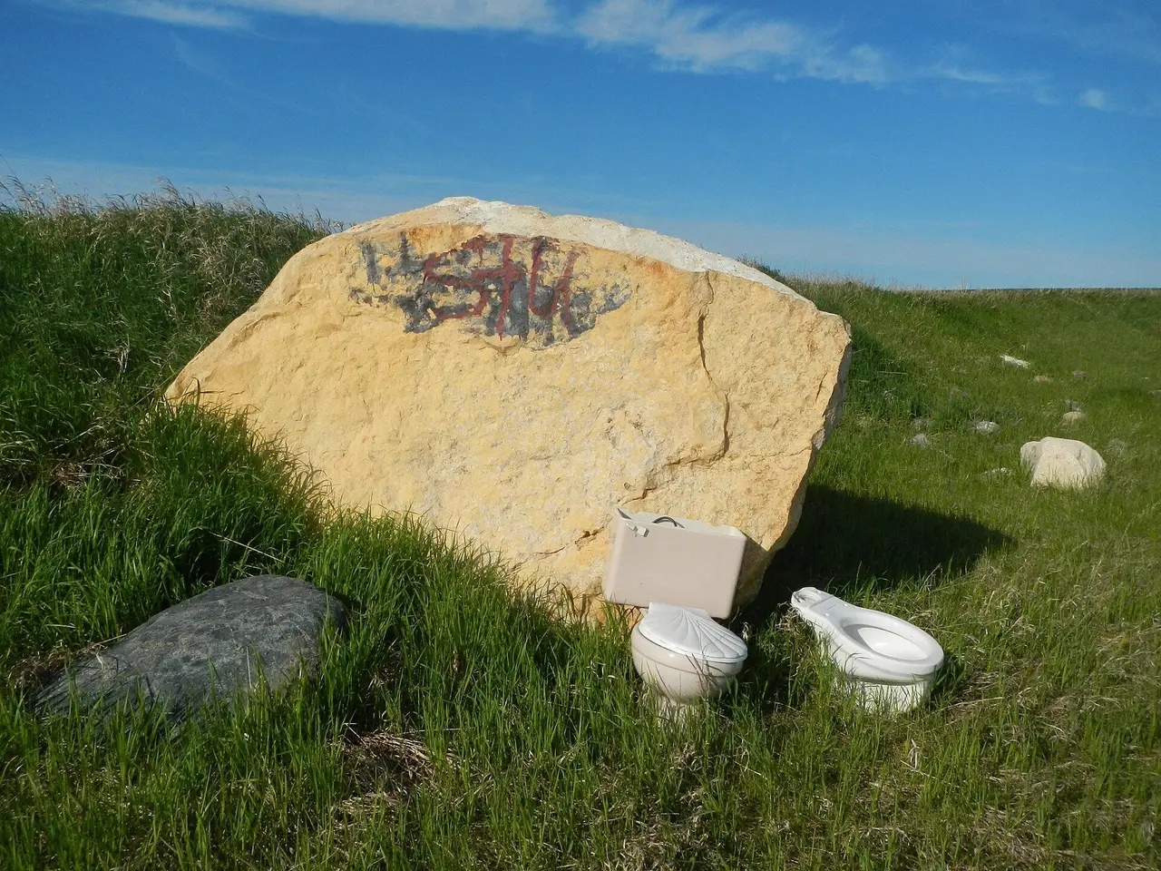 Painted boulder and toilets on the prairie, 2013